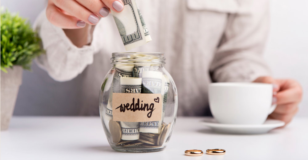 Putting cash in a jar to save for your wedding. 