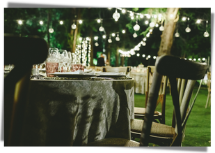 Outdoor wedding reception table, string lights, garden wedding